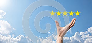 Man holds smart phone in hands and gives positive rating, icon five star symbol to increase rating of company concept on blue