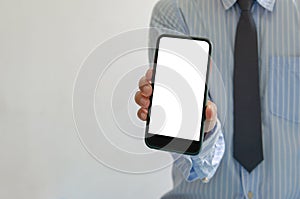 Man holds a smartphone in hand. Mobile phone mockup white screen blank Standing Against. use for marketing advertising or