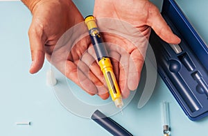 A man holds a syringe for subcutaneous injection of hormonal drugs in the IVF