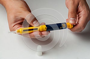 A man holds a syringe for subcutaneous injection of hormonal drugs in the IVF protocol in vitro fertilization