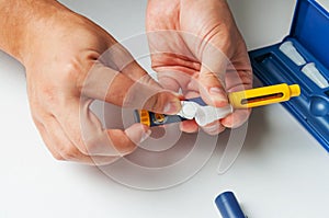 A man holds a syringe for subcutaneous injection of hormonal drugs in the IVF protocol in vitro fertilization