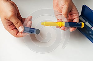 A man holds a syringe for subcutaneous injection of hormonal drugs in the IVF protocol in vitro fertilization