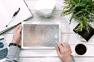 Man holds tablet pc with personal finance manager