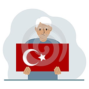 A man holds a Turkish flag in his hands. Concept for demonstration, national holiday, Turkey day or patriotism