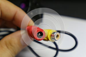 A man holds a TV Audio Video Cable Connector