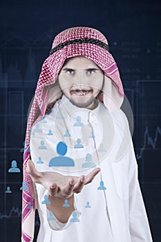 Man holds virtual icon of social network