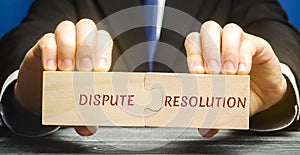 Man holds wooden puzzles with the words Dispute Resolution. Law and justice concept. Litigation, arbitration, mediation. ADR.