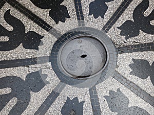 Man hole cover with tulip formed decorations in granito photo