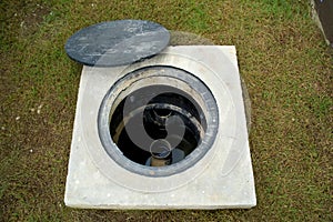 A man hole water and a hole of grease trap with the drain system around the house.