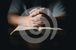 Man with holy bible in his hand, ready to pray, seek guidance from God through religious prayer. Person man, turned to God in