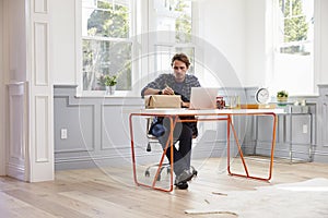 Man At Home Addressing Package For Mailing photo