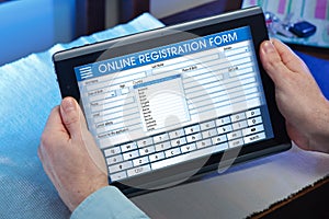 Man at home looking at blank online survey form on digital table photo