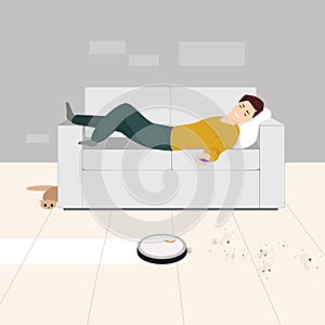 A man at home lying on the couch turns on the robot vacuum cleaner from the phone