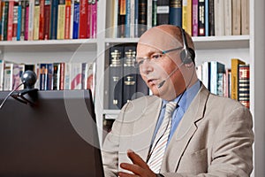 Man in home-office talking via skype