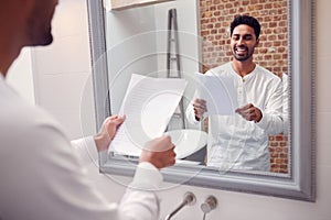 Man At Home Practising Giving Speech Or Presentation In Bathroom Mirror