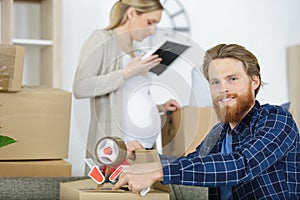 man at home sealing box for dispatch