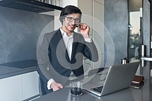 Businessman with headset at a video conference from his home computer photo