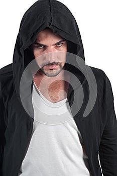 A man in a hood looks askance menacingly