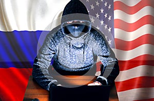 Man in hoodie is hacking personal data. Information security. Russian and American flags. Protection of information concept. Bad