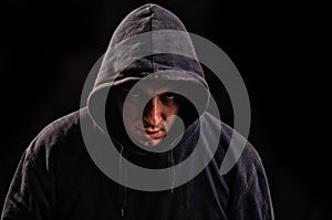 Man with hoodie or hooligan over dark background