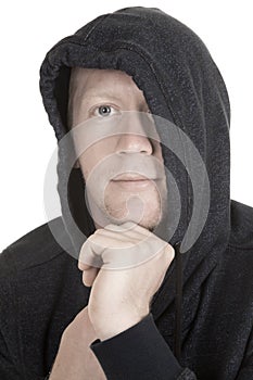 Man with hoodie over part of face hand on chin