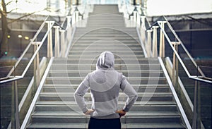 Man in hoodie preparing for stair run