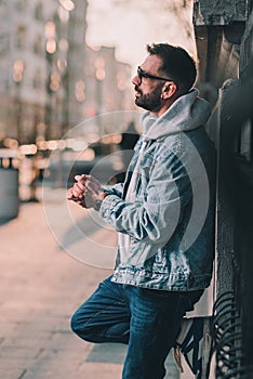 man in hoodie on a street sad