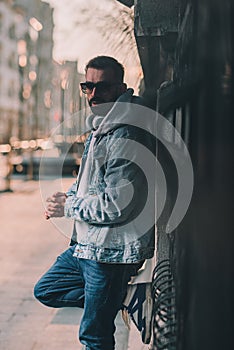 man in hoodie on a street sad