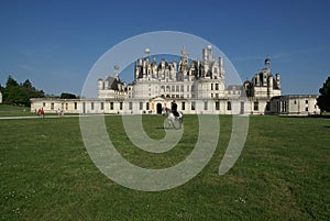 Man on a horse on the lawn near the castle of Chambord, Castles of the Loire, France