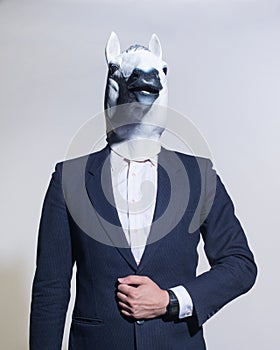 Man with a horse mask on a light background