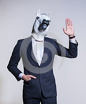 Man with a horse mask on a light background