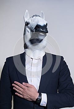 Man with a horse mask on a light background