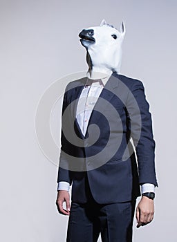 Man with a horse mask on a light background