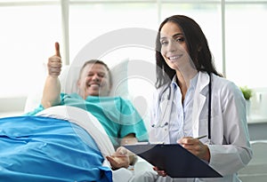 Man hospital bed shows gesture approval doctor