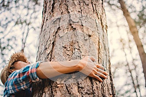 Man hug big tree color of hipster tone selective soft focus