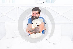 Man hug soft toy relaxing in bed. Make surprise concept. Gift for spouse. Cute teddy bear toy. Softness tenderness