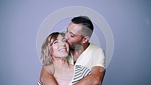 Man hugging his woman kissing with tenderness