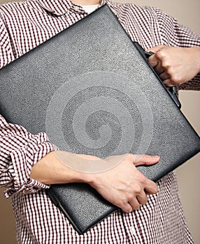 Man hugging a portfolio