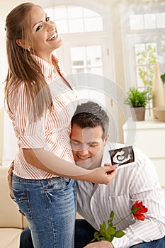 Man hugging pregnant woman