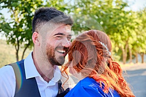 Man hugs his beloved woman smiling
