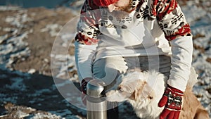 Man hugs his pet dog in winter frozen lake Happy smiling guy playing with border collie outdoors. Best friends together
