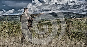 Man hunter aiming rifle nature background. Experience and practice lends success hunting. Guy hunting nature environment
