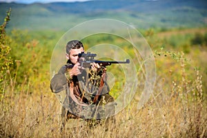 Man hunter aiming rifle nature background. Guy hunting nature environment. Hunting weapon gun or rifle. Hunting target