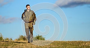 Man hunter carry rifle blue sky background. Experience and practice lends success hunting. Hunting weapon gun or rifle