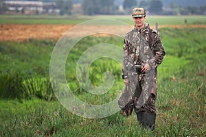 Man hunting ducks in wetlands