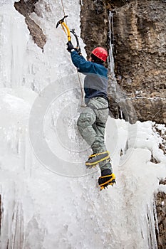 Man with ice axes and crampons photo