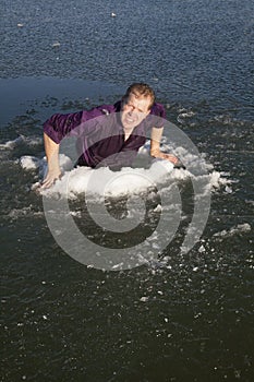 Man in ice hole climb out