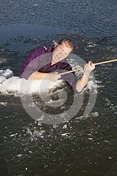 Man in ice hole pull out on rope looking