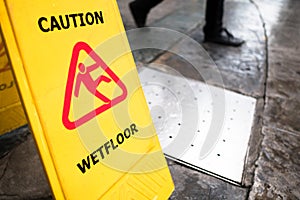 `man icon slip on wet floor`, yellow plastic stand signage