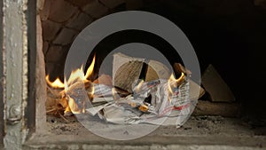 Man ignites a match in the wood oven. Ukrainian authentic old oven.